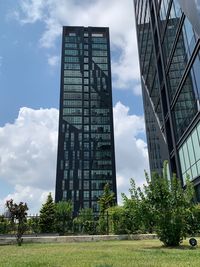 Low angle view of buildings against cloudy sky