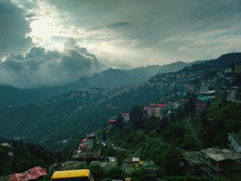 Houses on green hills in the clouds