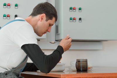 Side view of man working at home