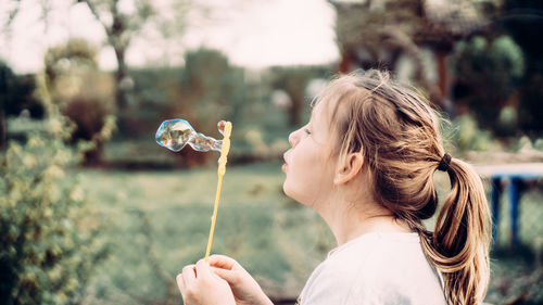 Portrait of girl holding bubbles