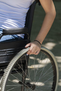 Midsection of person holding bicycle