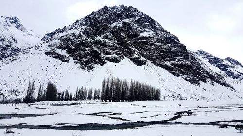 Scenic view of snow covered mountains against sky