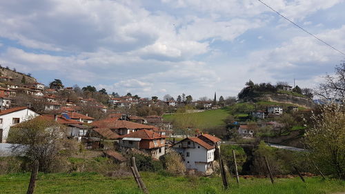 Houses in town against sky