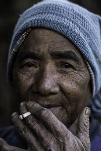 Close-up portrait of man smoking cigarette