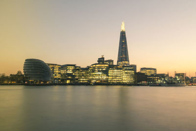 Illuminated city at waterfront