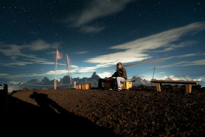 People at mountain peak against sky