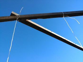 Low angle view of windmill against blue sky