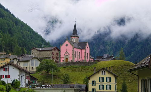 Panoramic view of buildings and mountains against sky