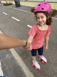 High angle view of boy sitting on road