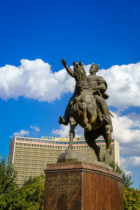 Low angle view of statue against blue sky