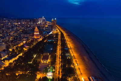 High angle view of city lit up at night