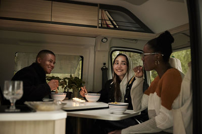 Friends having meal in camper van