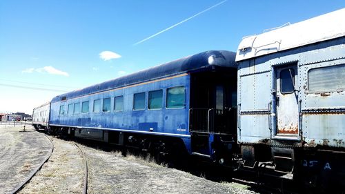 Old train stationary against sky