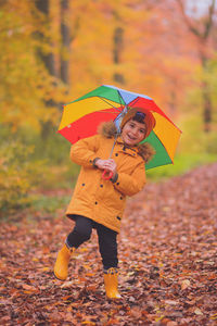 Rear view of woman holding umbrella