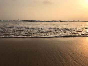 Scenic view of beach against sky during sunset