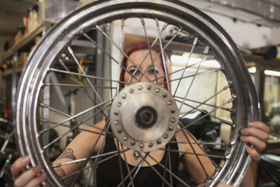 A young woman holding a wheel.