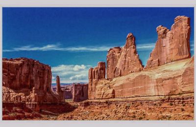 Scenic view of mountains against blue sky