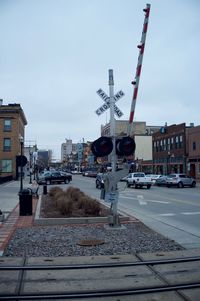 Train on railroad tracks in city against sky