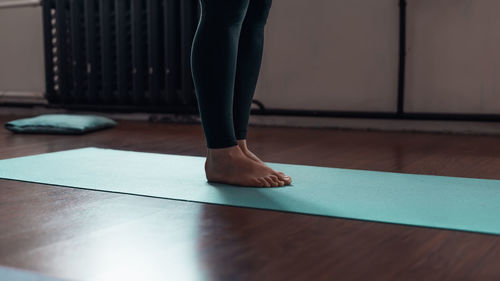 Low section of woman standing on hardwood floor