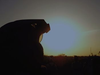 Side view portrait of silhouette man standing against sky during sunset