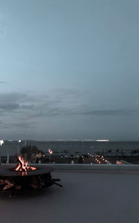 Scenic view of illuminated fire against sky at dusk