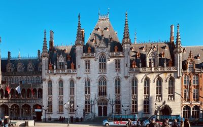 Buildings in city against blue sky