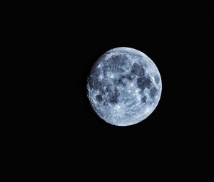 Low angle view of moon against black sky