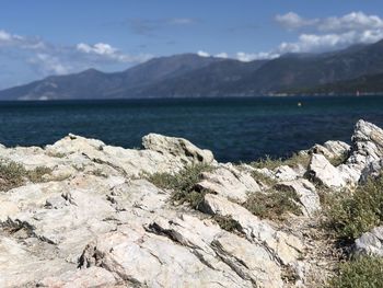 Scenic view of rocks and mountains against sky