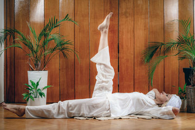 Woman practicing kundalini yoga, kriya exercises for the navel center and bowel waste elimination