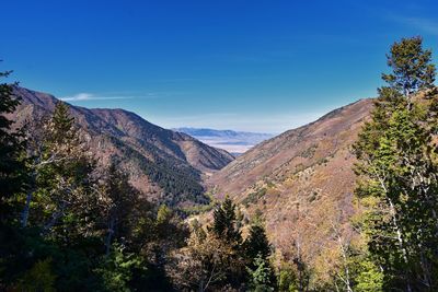 Scenic view of mountains against blue sky