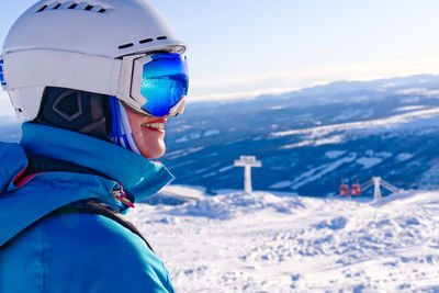 Rear view of man standing on snow covered mountain