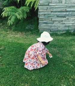 Rear view of girl on field