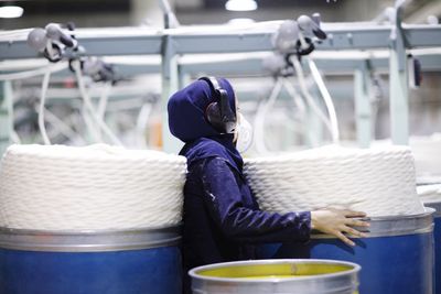 Midsection of man holding glass while sitting in basket