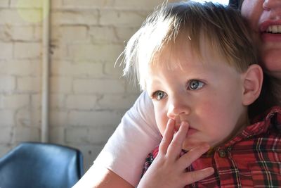 Midsection of mother with boy at home