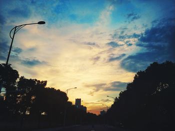 Low angle view of silhouette street against sky at sunset