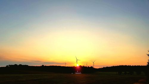 Silhouette of windmill at sunset