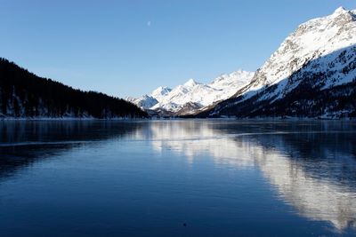 Scenic view of lake against blue sky at night