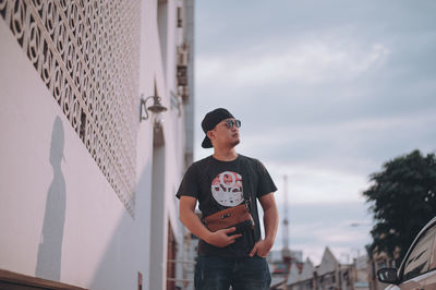 Full length of boy standing against sky