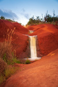 Scenic view of waterfall against sky