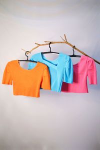 Clothes hanging on wood stick against white background