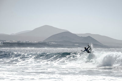 People surfing in sea