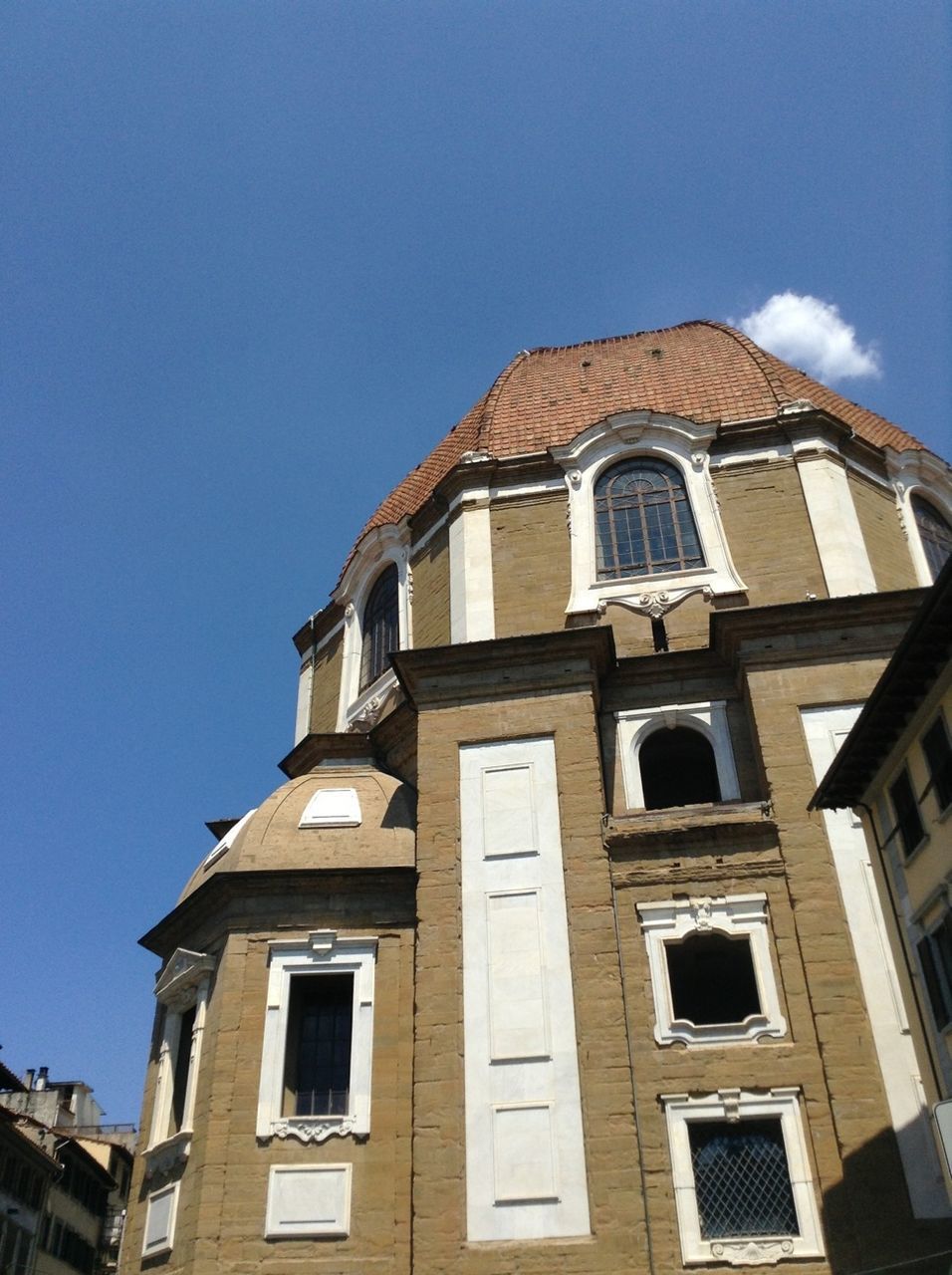 architecture, building exterior, low angle view, built structure, window, sky, blue, clear sky, day, building, high section, outdoors, facade, no people, sunlight, church, city, residential building, religion, history