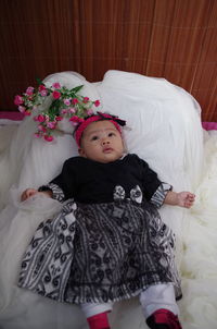 High angle view of baby relaxing on bed at home