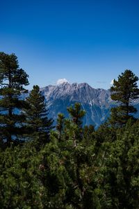 Scenic view of mountains against clear blue sky