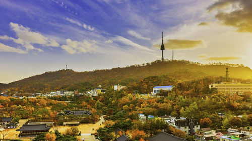 High angle view of trees and buildings in city against sky