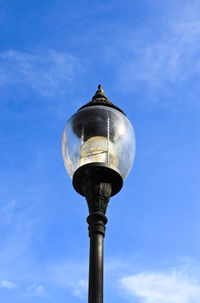 Low angle view of street light against sky
