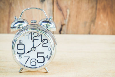 Close-up of alarm clock on table