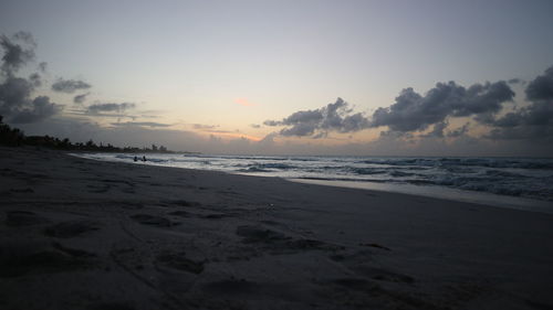 Scenic view of beach against sky during sunset