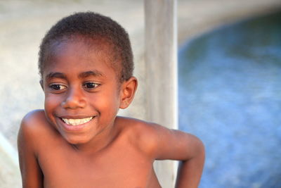 Portrait of cute boy smiling in swimming pool