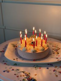 Close-up of birthday cake on table with candles